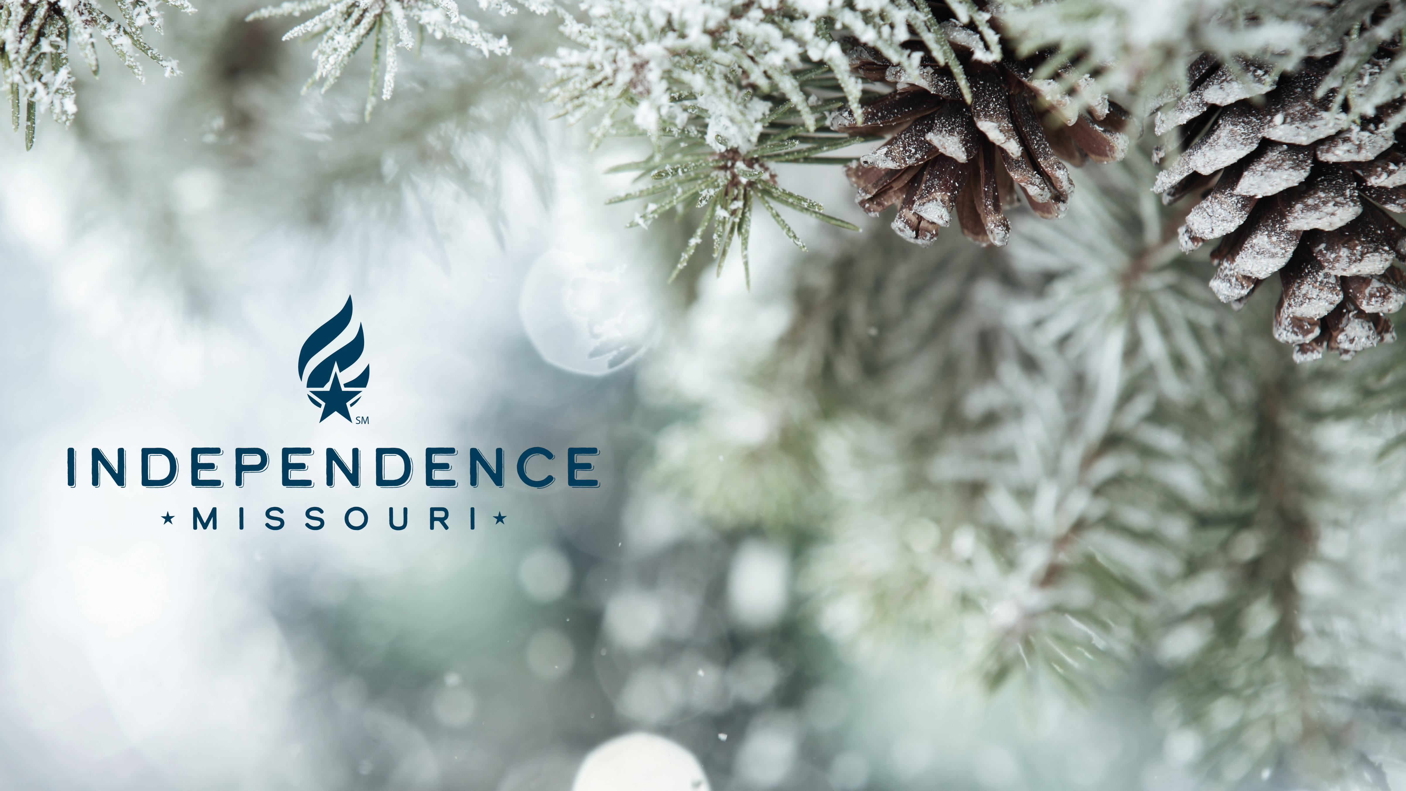 Image of pine needles, pinecones, and snow with the City of Independence blue logo