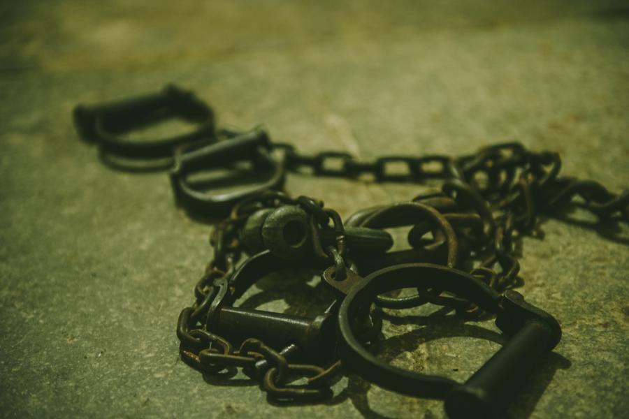Image of old chain handcuffs on jail floor