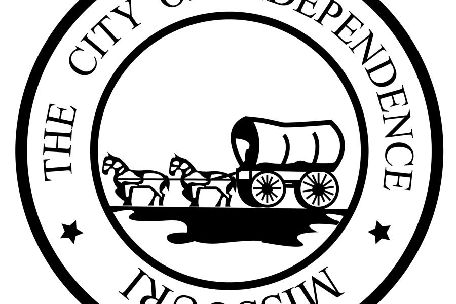The City of Independence Missouri seal with a covered wagon in the center of a circle with text around it. 