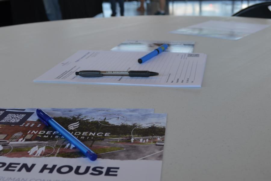 a flyer on a table with the words 'Open House' being the only things visible on the form 