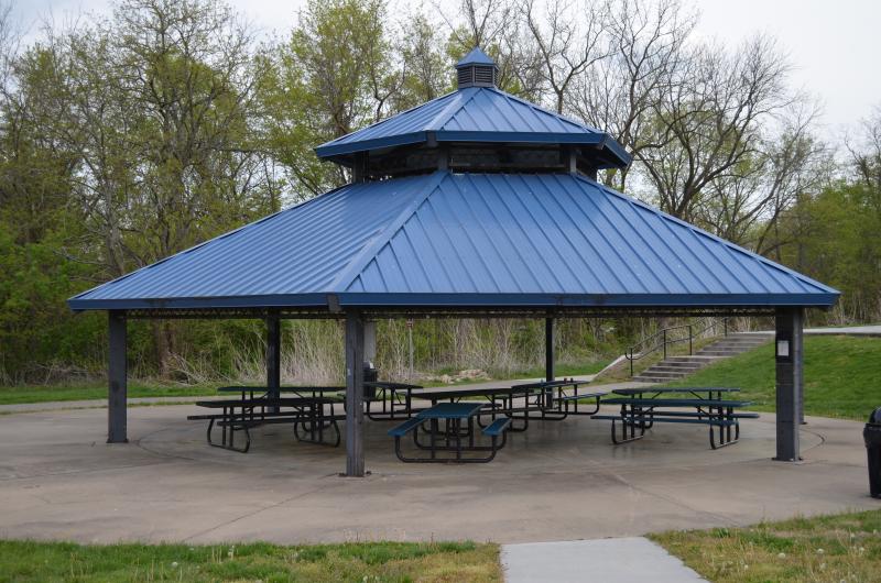 A picture of the Mill Creek Park pavilion with picnic tables under the structure.