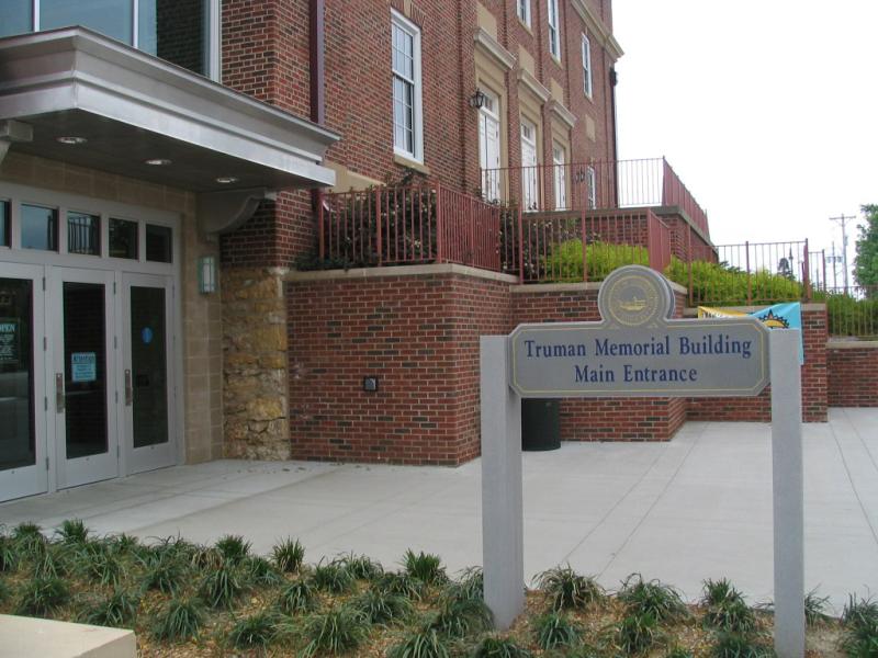 main entrance of TMB showing sign, main doors and landscaping