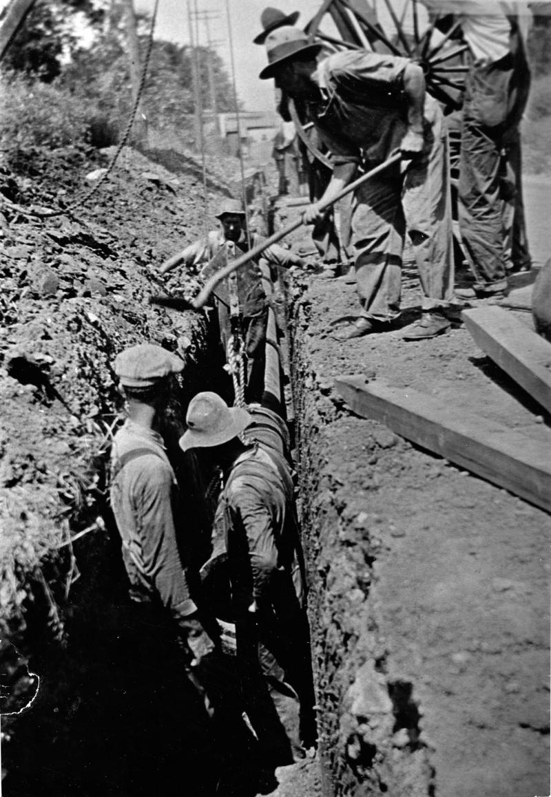 Historical photo of men digging trench for water lines