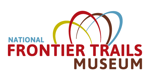 An image of the National Frontier Trails Museum logo in blue, red and brown with four arch shapes above the name.