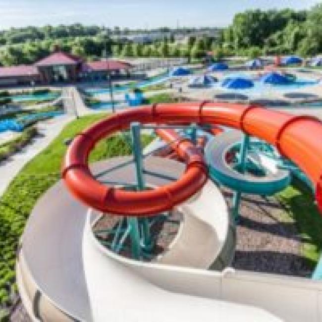 A top-down view of an orange, tube water slide at Adventure Oasis Water Park
