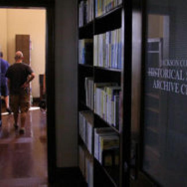 An interior shot of the Jackson County Historical Society featuring a dimly-lit bookshelf