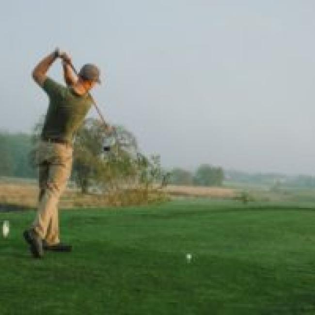 A golfer tees off while at the Drumm Farm Golf Course